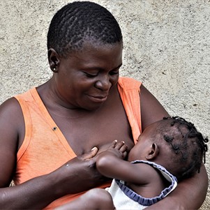 Anastacia breastfeeding her daughter.